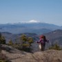 Kim hiking up with the glorious Mt Washington behind her.